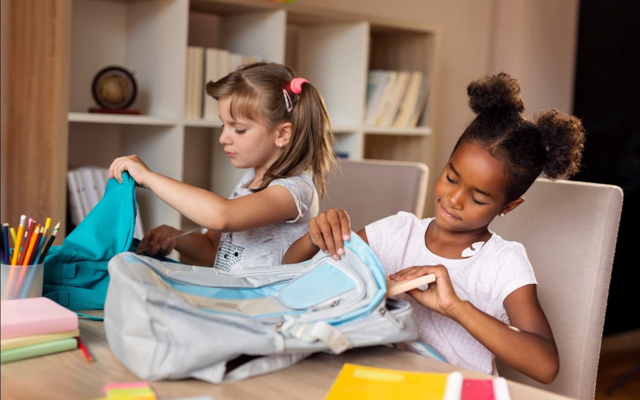 Children packing their school bags.