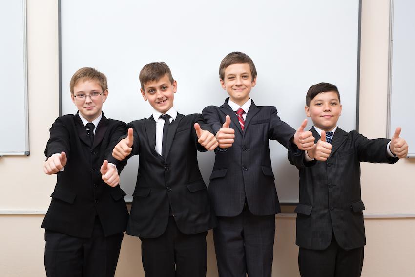 Group of Year 7 boys in school uniform with their thumbs up