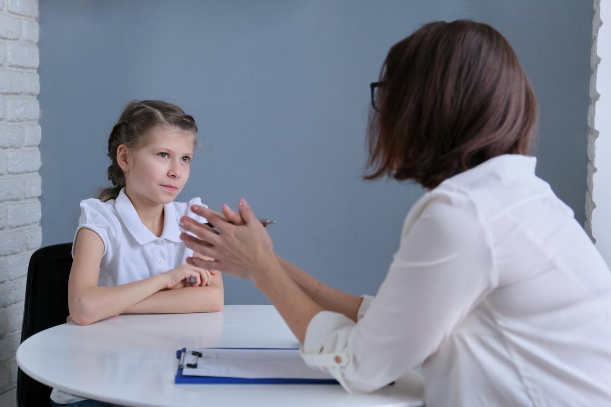Young girl being interviewed by a child psychologist