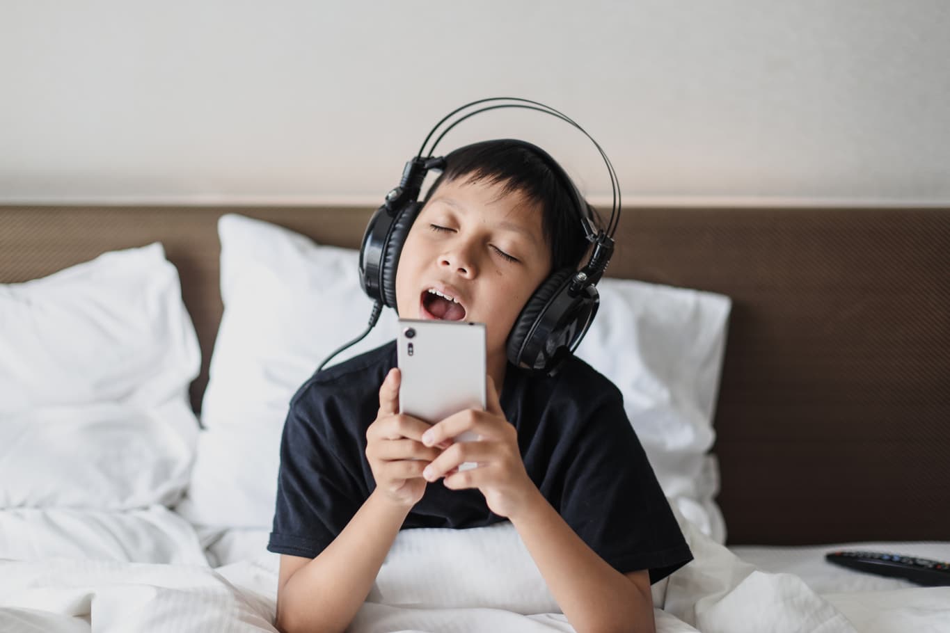 A child listening to music and singing
