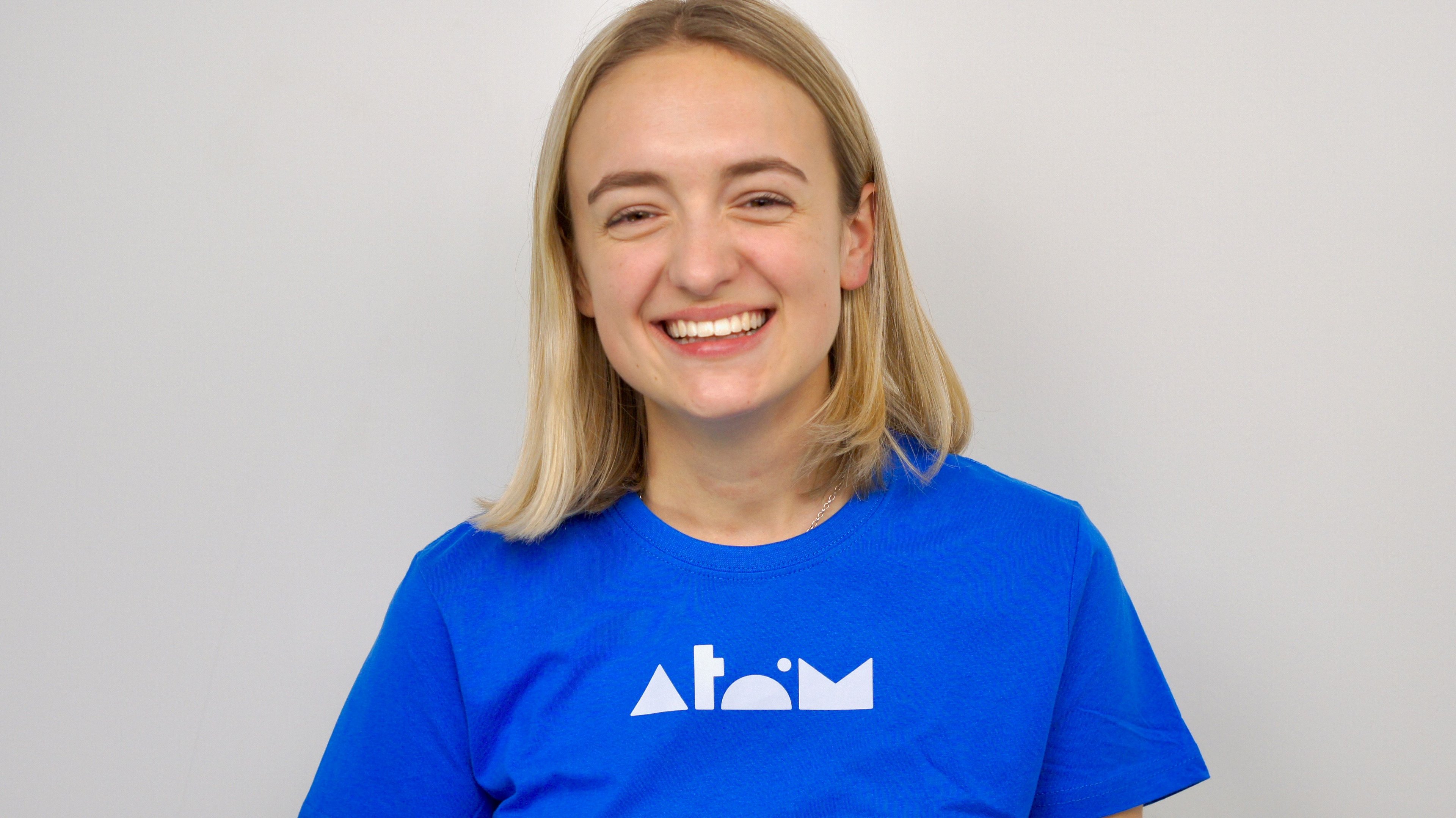 Smiling blonde woman in Atom t-shirt