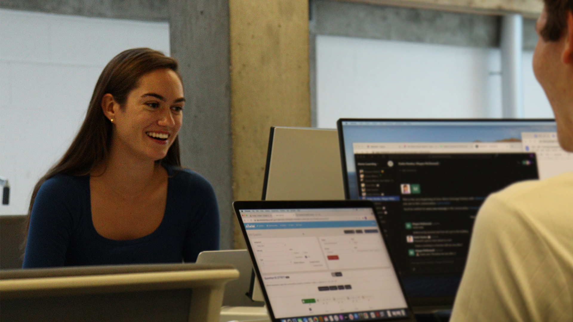 Atom employee with brown hair smiling